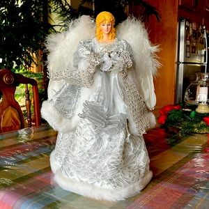 Tree or tabletop 16” angel is adorned in silver and white trimmings.